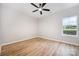 Bedroom with a ceiling fan, light-colored walls, wood-look flooring, and a bright window view at 1011 Indiana St, Kannapolis, NC 28083