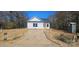Charming single-story home with white siding, a black roof, and visible construction progress in the front yard at 1011 Indiana St, Kannapolis, NC 28083