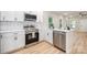 Modern kitchen features stainless steel appliances, white cabinets, and wood flooring at 1011 Indiana St, Kannapolis, NC 28083