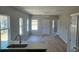 Open living room with lots of natural light, a ceiling fan, and wood-look floors at 1011 Indiana St, Kannapolis, NC 28083