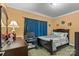 Cozy bedroom with dark wood furniture, a computer desk, and blue accents at 3951 Springs Rd, Conover, NC 28613