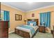 Comfortable bedroom with a wood bed frame, soft blue bedding, and ample natural light at 3951 Springs Rd, Conover, NC 28613