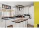 Bright kitchen with an island, white cabinetry, contrasting countertops and modern appliances at 3951 Springs Rd, Conover, NC 28613