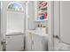Functional laundry room with white cabinets, shelving, and modern appliances, including a deep freezer at 3951 Springs Rd, Conover, NC 28613