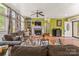 Spacious living room featuring a fireplace, herringbone floors, and lots of natural light at 3951 Springs Rd, Conover, NC 28613