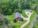 An aerial view of a unique brick home with a black metal roof and a detached garage at 6620 Old Concord Rd, Salisbury, NC 28146