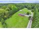 Aerial view of a red brick home surrounded by beautiful green landscaping and mature trees at 6620 Old Concord Rd, Salisbury, NC 28146