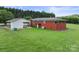 Exterior view of a brick home with white carport, and well-maintained lawn at 6620 Old Concord Rd, Salisbury, NC 28146