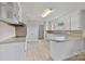 Bright kitchen with white cabinets, countertops, and stainless steel appliances at 6620 Old Concord Rd, Salisbury, NC 28146