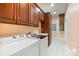 Laundry room boasts washer, dryer, wood cabinets, sink, and tiled floors at 6620 Old Concord Rd, Salisbury, NC 28146