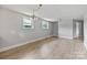Living room with wood flooring, natural light, neutral walls, and a chandelier at 6620 Old Concord Rd, Salisbury, NC 28146