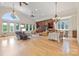 Bright, open-concept living room with wood floors, large windows and elegant chandeliers at 6620 Old Concord Rd, Salisbury, NC 28146