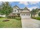 Two-story house with white and beige siding and a two-car garage at 5006 Sand Trap Ct, Monroe, NC 28112