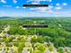 Beautiful aerial view of a neighborhood with mature trees and a clear blue sky close to Downtown Gastonia at 2627 Ashbourne Dr, Gastonia, NC 28056