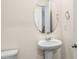 Elegant powder room with pedestal sink, oval mirror, and modern fixtures at 4120 Village Nw Blvd, Conover, NC 28613