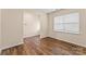 Bright bedroom featuring wood floors, neutral walls, and a large window with horizontal blinds at 4120 Village Nw Blvd, Conover, NC 28613
