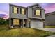 Two-story home with stone accents, gray siding, a two-car garage, and a well-manicured lawn at 4120 Village Nw Blvd, Conover, NC 28613