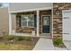 Inviting front porch with stone facade, decorative columns, and a stylish front door at 4120 Village Nw Blvd, Conover, NC 28613