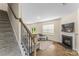 Bright living room with fireplace, hardwood floors, and stairs leading to upper level at 4120 Village Nw Blvd, Conover, NC 28613