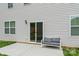 Back patio with gray outdoor sofa and sliding glass doors at 4120 Village Nw Blvd, Conover, NC 28613