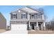 Charming two-story home showcasing stone accents, gray siding, and a welcoming entrance at 3655 Mercer St, Terrell, NC 28682