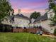 Expansive backyard with lush lawn, patio with pergola, and brick accents, perfect for outdoor entertaining at 4409 Solemn Point Ln, Charlotte, NC 28216