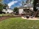 Landscaped backyard with patio, fire pit, and stairs at 4409 Solemn Point Ln, Charlotte, NC 28216