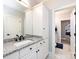 Bathroom with granite countertop, white cabinets, and black fixtures at 4409 Solemn Point Ln, Charlotte, NC 28216