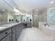 Large bathroom with double vanity, soaking tub, and walk-in shower at 4409 Solemn Point Ln, Charlotte, NC 28216