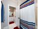 Bathroom with shower/tub combo, white vanity, and striped curtain at 4409 Solemn Point Ln, Charlotte, NC 28216