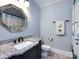 Bathroom with granite countertop, a white sink, and a shower at 4409 Solemn Point Ln, Charlotte, NC 28216