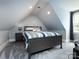Cozy bedroom with sloped ceilings and gray carpeting at 4409 Solemn Point Ln, Charlotte, NC 28216