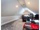 Bedroom with sloped ceilings, gaming setup, and comfy seating at 4409 Solemn Point Ln, Charlotte, NC 28216