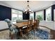 Elegant dining room features a wood table, chandelier, and built-in bench at 4409 Solemn Point Ln, Charlotte, NC 28216