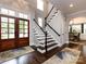 Two-story foyer with hardwood floors, staircase, and double doors at 4409 Solemn Point Ln, Charlotte, NC 28216