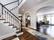 Elegant entryway with hardwood floors, a grand staircase, and archways at 4409 Solemn Point Ln, Charlotte, NC 28216