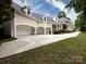 House exterior showcasing a three-car garage and manicured lawn at 4409 Solemn Point Ln, Charlotte, NC 28216