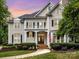 Charming two-story home boasts a balcony, manicured lawn, and inviting entryway, with classic black shutters at 4409 Solemn Point Ln, Charlotte, NC 28216