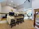 Game room with sectional sofa, bar stools, and a large TV at 4409 Solemn Point Ln, Charlotte, NC 28216