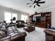 Gathering room with leather sofas, large TV, and built-in shelving at 4409 Solemn Point Ln, Charlotte, NC 28216