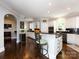 White kitchen with stainless steel appliances and an island at 4409 Solemn Point Ln, Charlotte, NC 28216