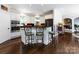 Island kitchen with stainless steel appliances and dark wood floors at 4409 Solemn Point Ln, Charlotte, NC 28216