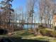 Serene backyard view overlooking a calm lake at 4409 Solemn Point Ln, Charlotte, NC 28216
