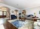 Living room with hardwood floors, a gray sofa, and a large rug at 4409 Solemn Point Ln, Charlotte, NC 28216