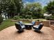 Brick patio with fire pit and comfortable seating area at 4409 Solemn Point Ln, Charlotte, NC 28216