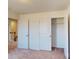 Bedroom includes neutral walls, carpet flooring, and a closet with double doors at 2054 Van Buren Rd, Sherrills Ford, NC 28673