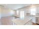 Open kitchen with white cabinets, stainless steel appliances, granite countertops, and wood-look flooring at 2054 Van Buren Rd, Sherrills Ford, NC 28673
