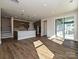 A living room showcases an open floor plan with wood floors and a modern kitchen, leading to a sliding glass door at 139 Armstrong Rd, Belmont, NC 28012