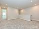 A carpeted loft area with an open doorway and a staircase at 139 Armstrong Rd, Belmont, NC 28012