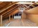 Unfinished attic space with wooden floors and beams at 1626 S Wendover Rd, Charlotte, NC 28211